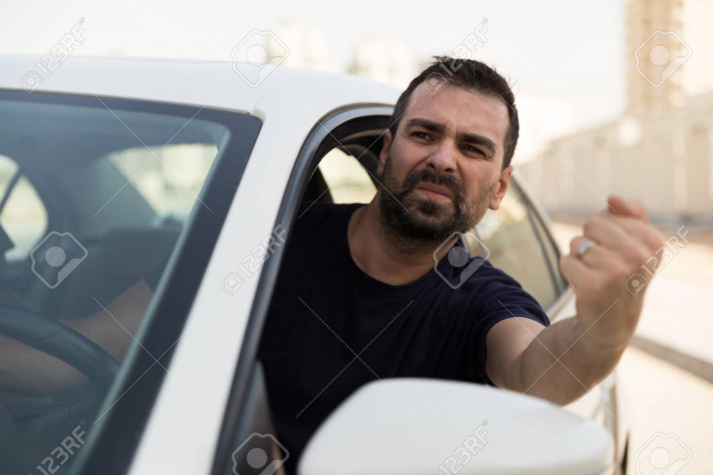107055560-angry-driver-pissed-off-by-drivers-in-front-of-him-and-gesturing-with-hands-road-rage-traffic-jam-co.jpg